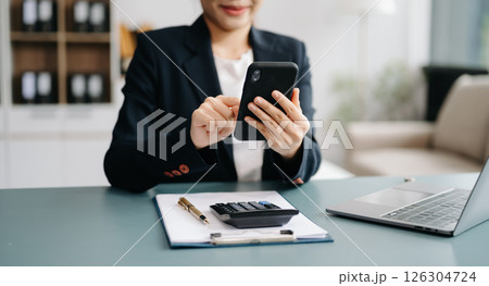 Confident businessman working on laptop,tablet and smartphone at her workplace at office. Confident businessman working on laptop,tablet and smartphone at her workplace at office. 126304724