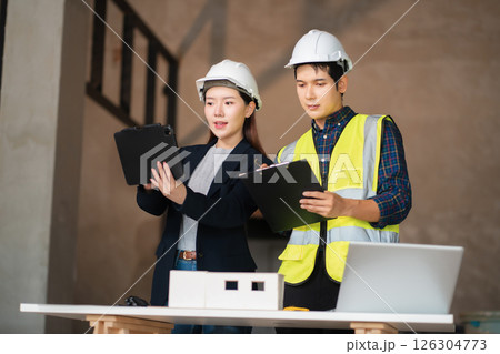 Engineer teams meeting working together wear worker helmets hardhat on construction site. 126304773