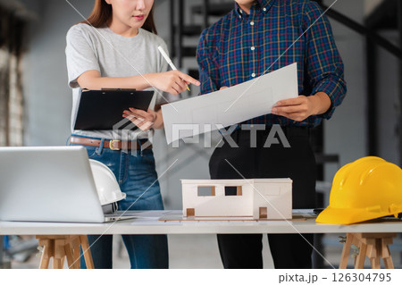 Construction engineers discussion with architects at construction site or building site. Construction engineers discussion with architects at construction site or building site. 126304795
