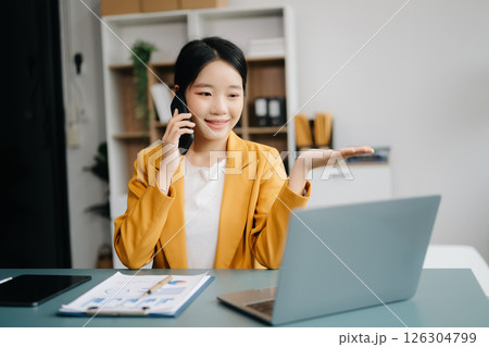 Businesswoman Analyzing Finance on Tablet and Laptop at modern Office Desk tax, report, accounting, statistics, and analytical research concept Businesswoman Analyzing Finance on Tablet and Laptop at modern Office Desk tax, report, accounting, statistics, and analytical research concept 126304799