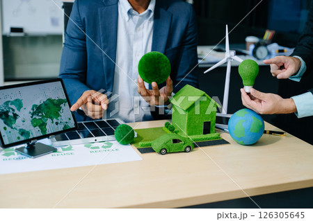 Business team people planning hand using laptop for working technology and business Net zero and carbon neutral concept. 126305645