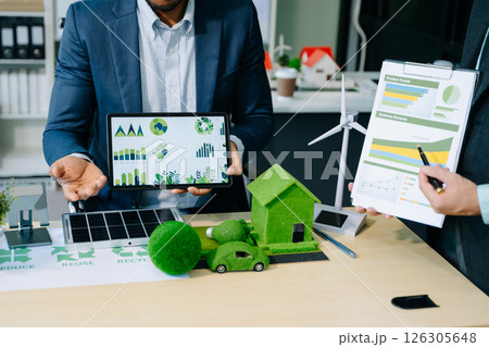 Business team people planning hand using laptop for working technology and business Net zero and carbon neutral concept. 126305648