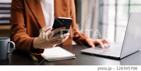 business documents on office table with smart phone and digital tablet and graph financial and woman working business documents on office table with smart phone and digital tablet and graph financial and woman working 126305706