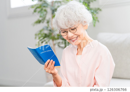 おくすり手帳を確認するシニア女性 126306766