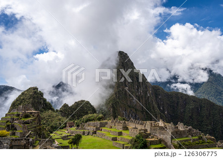 Panoramic view of Machu Picchu ruins surrounded by misty mountains, Peru 126306775