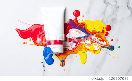 A white tube surrounded by vibrant red, yellow, and blue paint spills on a marble surface, creating an artistic mess. A white tube surrounded by vibrant red, yellow, and blue paint spills on a marble surface, creating an artistic mess. 126307085