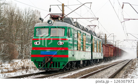 Old Soviet electric locomotive with a heavy freight train in winter in Kyiv Oblast of Ukraine Old Soviet electric locomotive with a heavy freight train in winter in Kyiv Oblast of Ukraine 126307971