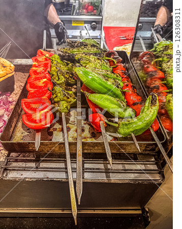 Colorful skewers of grilled vegetables in a kitchen with a smoky ambiance and cooking tools. High quality photo Colorful skewers of grilled vegetables in a kitchen with a smoky ambiance and cooking tools. High quality photo 126308311