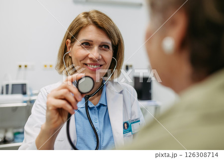 Geriatrician listening to senior patient's heartbeat. Geriatrician listening to senior patient's heartbeat. 126308714