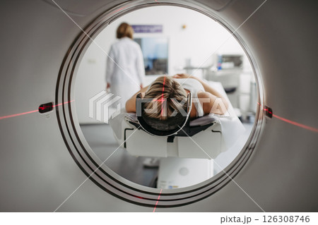CT scanner view of patient during medical imaging procedure. CT scanner view of patient during medical imaging procedure. 126308746