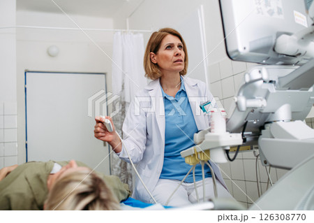 Doctor performing diagnostic ultrasound during preventive care 126308770