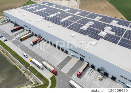 Logistics centers with solar panels on roofs. Aerial view Logistics centers with solar panels on roofs. Aerial view 126309450