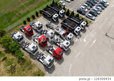 Parking of new and used trucks near the distribution and service center. Aerial view Parking of new and used trucks near the distribution and service center. Aerial view 126309454