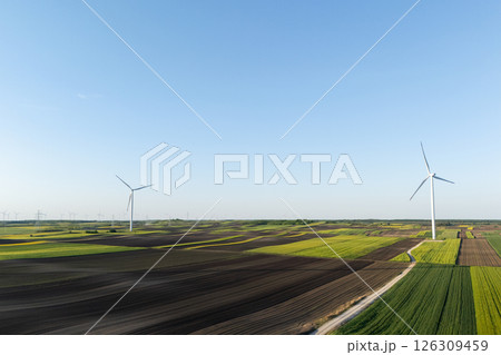 Aerial view of wind turbines on an agricultural field. Sustainable energy 126309459