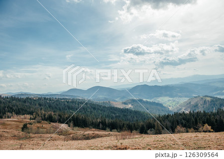 Expansive mountain valley view beneath a dramatic spring sky 126309564