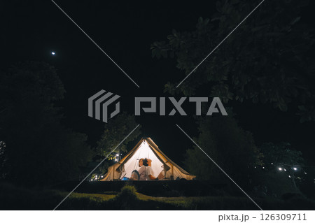 asian couple relax in camping tent on summer vacation asian couple relax in camping tent on summer vacation 126309711