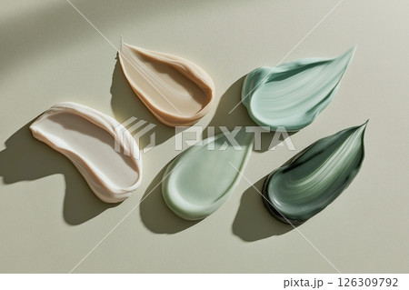 Smooth, colorful pebbles lining a lakes shore, reflecting the warm hues of a vibrant sunset sky 126309792