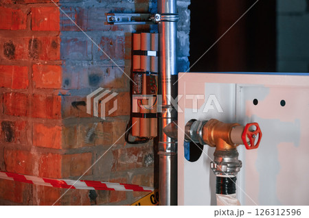 Bomb is planted near fire hose. Explosive is indoors. Police investigation. Conception of terror Bomb is planted near fire hose. Explosive is indoors. Police investigation. Conception of terror 126312596