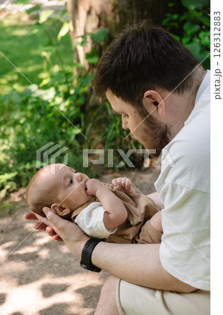 Father Holding Baby in Sunny Park Father Holding Baby in Sunny Park 126312883