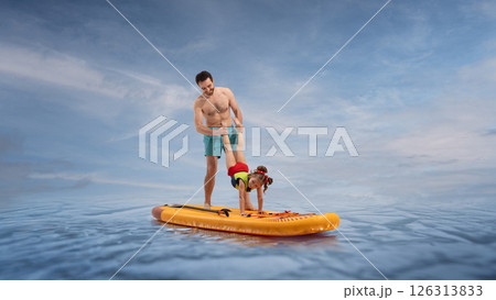 Father helps cheerful daughter perform handstand on sup board on ocean under blue sky. Composite image, collage. 126313833