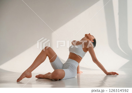 Young caucasian woman with slim body shape is indoors in the studio 126314592