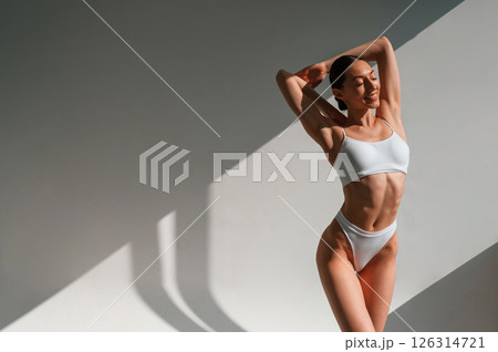 Slim body shape. Young caucasian woman is indoors in the studio Slim body shape. Young caucasian woman is indoors in the studio 126314721