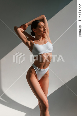 Slim body shape. Young caucasian woman is indoors in the studio Slim body shape. Young caucasian woman is indoors in the studio 126314722