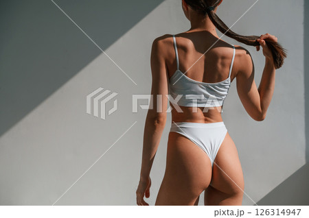 Close up view of the body. Young caucasian woman is indoors in the studio 126314947