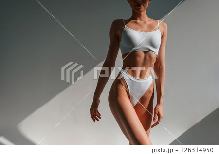 Close up view of the body. Young caucasian woman is indoors in the studio Close up view of the body. Young caucasian woman is indoors in the studio 126314950