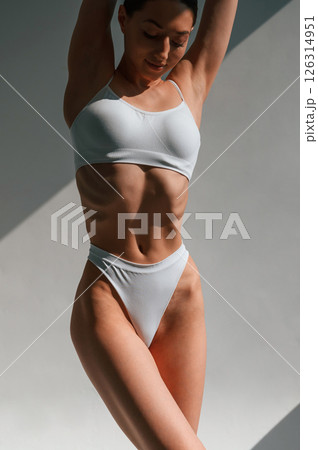 Close up view of the body. Young caucasian woman is indoors in the studio 126314951