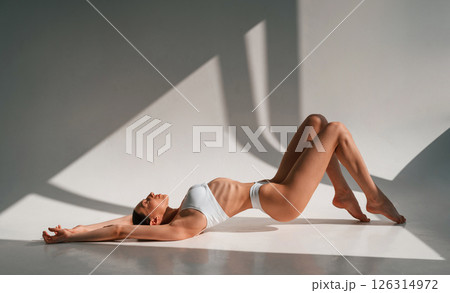 Young caucasian woman with slim body shape is indoors in the studio Young caucasian woman with slim body shape is indoors in the studio 126314972