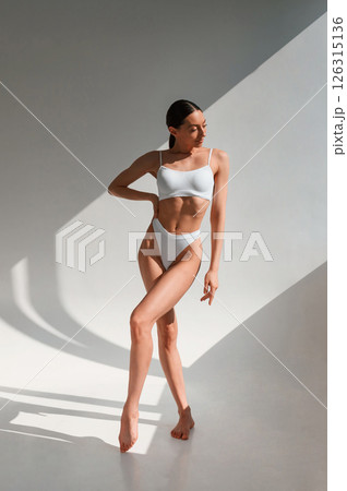 Fitness body type. Young caucasian woman is indoors in the studio 126315136