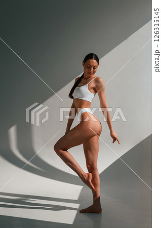 Fitness body type. Young caucasian woman is indoors in the studio Fitness body type. Young caucasian woman is indoors in the studio 126315145