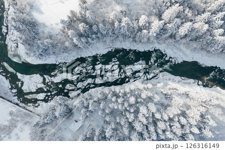 Top aerial view of river and trees that covered in snow in the Carpathian mountains. Majestic landscape, background Top aerial view of river and trees that covered in snow in the Carpathian mountains. Majestic landscape, background 126316149