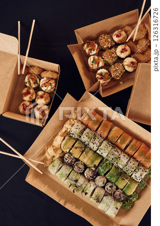 Top view of sushi rolls that is in the paper eco boxes on the table 126316726