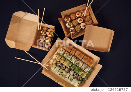 Top view of sushi rolls that is in the paper eco boxes on the table 126316727
