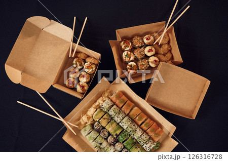 Top view of sushi rolls that is in the paper eco boxes on the table 126316728
