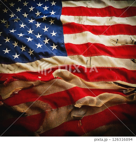 Worn american flag with frayed edges and faded colors Worn american flag with frayed edges and faded colors 126316894