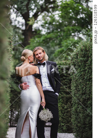 Stylish young beautiful newlywed couple posing at wedding in beautiful green park 126318599