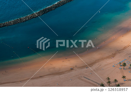 Close-up view of a tranquil sandy beach with turquoise water in Tenerife Close-up view of a tranquil sandy beach with turquoise water in Tenerife 126318957