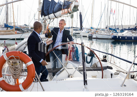 Men in suits relaxing on a yacht in the seaport 126319164