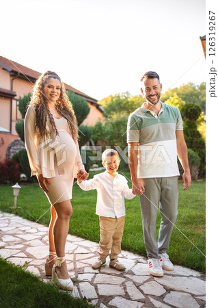 Joyful family moment during golden hour in the garden Joyful family moment during golden hour in the garden 126319267