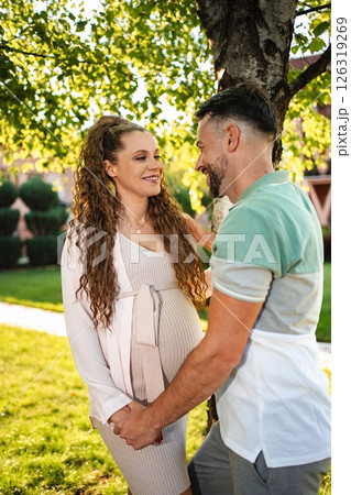 Couple enjoys sunny park moments during pregnancy Couple enjoys sunny park moments during pregnancy 126319269