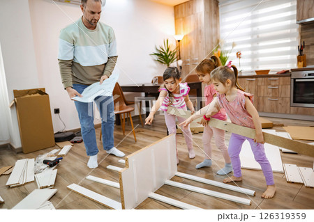 Creative family time while assembling furniture in a cozy home Creative family time while assembling furniture in a cozy home 126319359