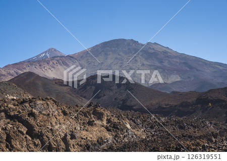 Winter view on colorful volcano Pico del Teide with snow spots from hiking trail Samara. Mountains and lava fields against blue sky. El Teide National Park, Tenerife, Canary Islands, Spain 126319551