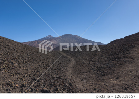 Winter view on colorful volcano Pico del Teide with snow spots from hiking trail Samara. Mountains and lava fields against blue sky. El Teide National Park, Tenerife, Canary Islands, Spain 126319557