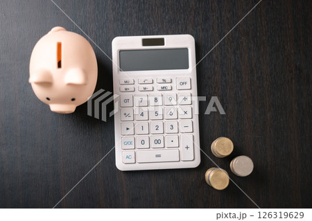 Finance bank tax expense accounting budget money businessman hand use calculator Financial calculate accountant close up calculator with graph chart write office desk Business expense analysis saving 126319629