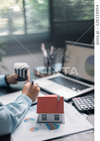 Finance bank tax expense accounting budget money businessman home for Business expense analysis saving use Financial calculate accountant close up calculator with graph chart hand write office desk 126319954