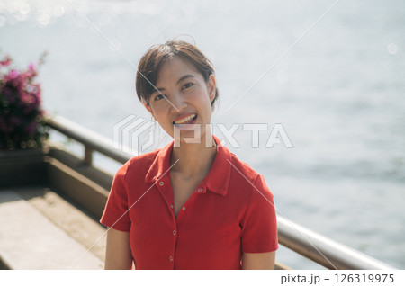 Southeast asian woman young female entrepreneur enjoys remote work as small business owner businesswoman by water on sunny day with cheerful expression outdoors Southeast asian woman young female entrepreneur enjoys remote work as small business owner businesswoman by water on sunny day with cheerful expression outdoors 126319975