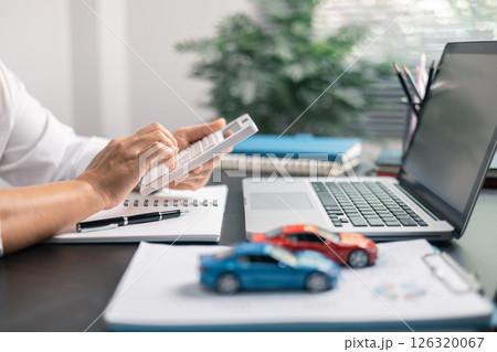 Finance bank tax expense accounting budget money businessman hand for Business expense analysis saving use car Financial calculate accountant close up calculator with graph chart write office desk 126320067